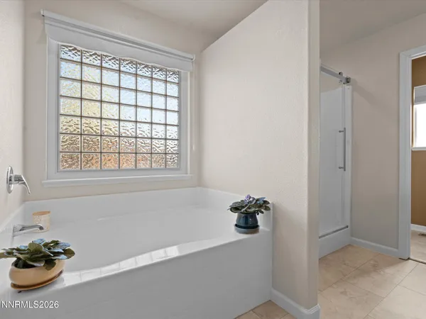 a en suite bathroom with a granite countertop sink and mirror