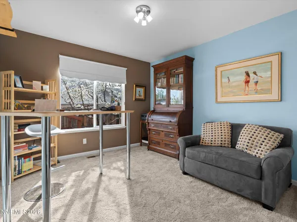 a view of a patio with couches table and chairs with wooden floor and fence