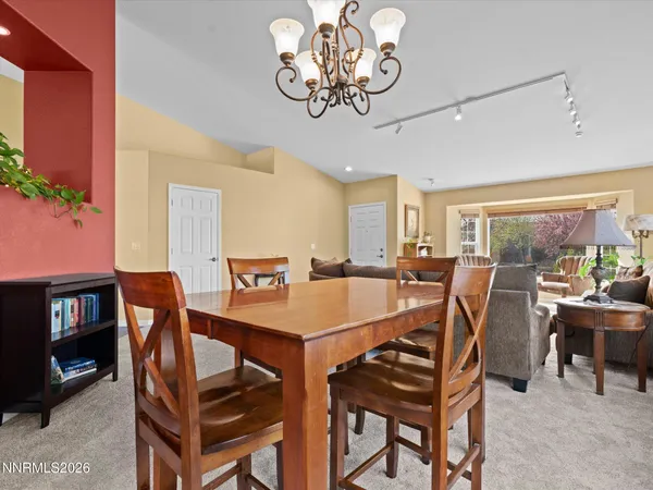 a view of a dining room with furniture and a floor to ceiling window