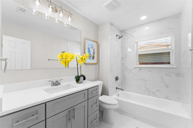 a bathroom with a sink a toilet and bathtub