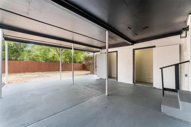 a view of a room with wooden floor and a large window