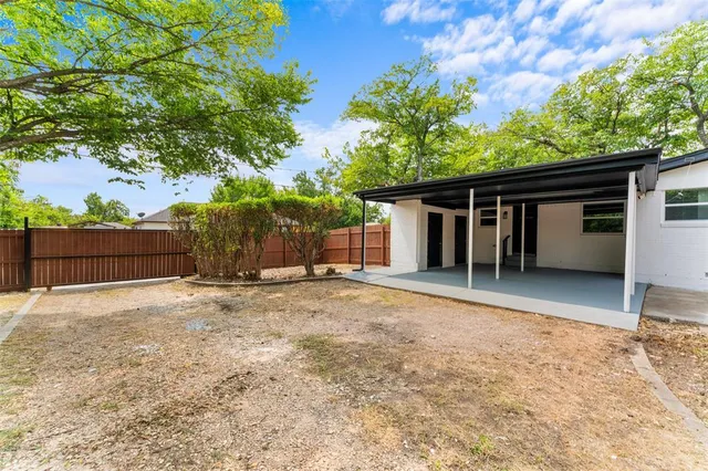 front view of a house with a yard and a garage