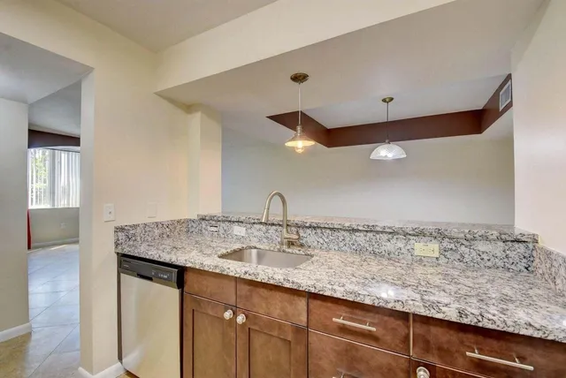a kitchen with a sink and a mirror