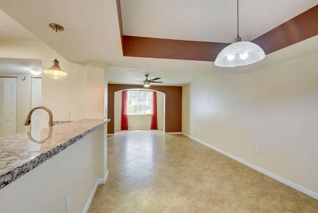 a view of a kitchen with a sink and chandelier