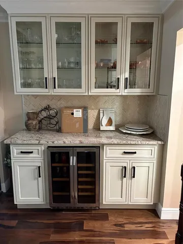 a kitchen with granite countertop a stove and a wooden floor