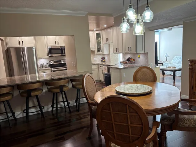 a view of a dining room with furniture and wooden floor