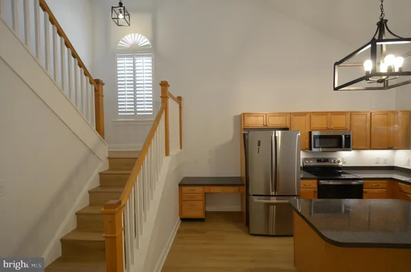a kitchen with stainless steel appliances a refrigerator and a stove top oven