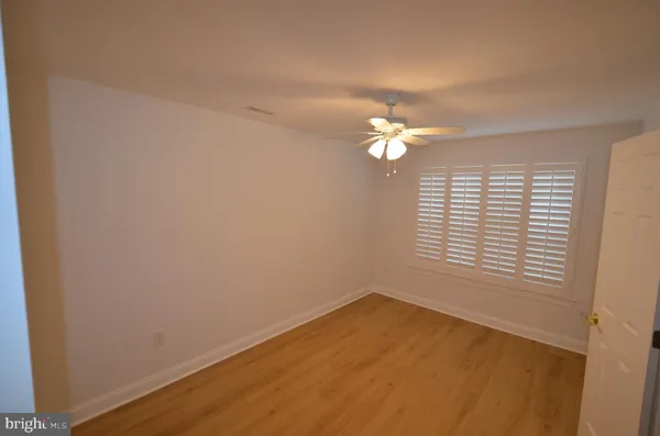 an empty room with wooden floor