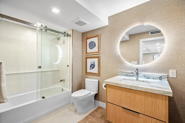 a bathroom with a toilet sink and a mirror