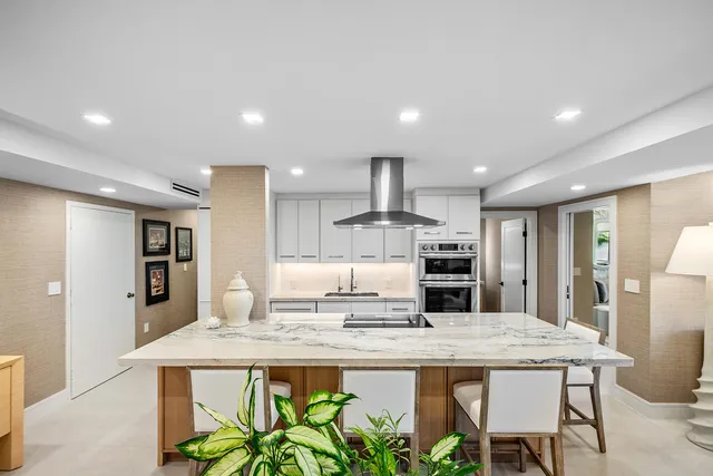 a kitchen with kitchen island granite countertop a sink and counter space