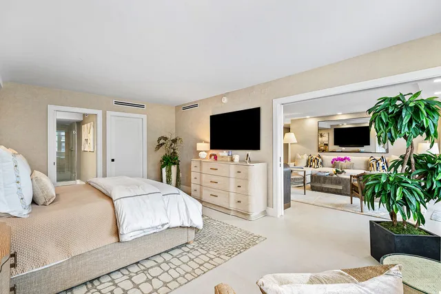 a bedroom with a flat screen television and a bed