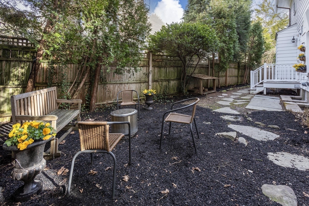 57 Hedge Road Brookline, MA 02445 - Photo 34 of 37 a view of a backyard with table and chairs and a barbeque