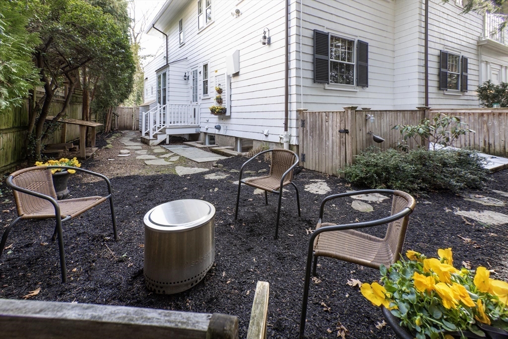 57 Hedge Road Brookline, MA 02445 - Photo 35 of 37 a view of a patio with table and chairs and potted plants