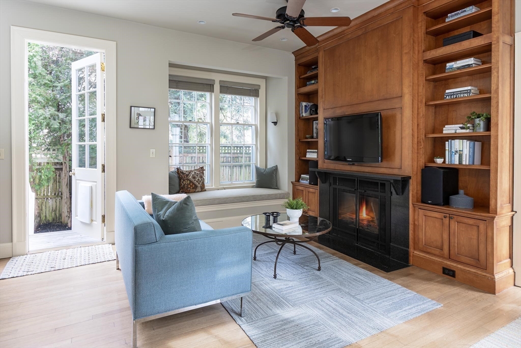 57 Hedge Road Brookline, MA 02445 - Photo 5 of 37 a living room with furniture a flat screen tv and a fireplace