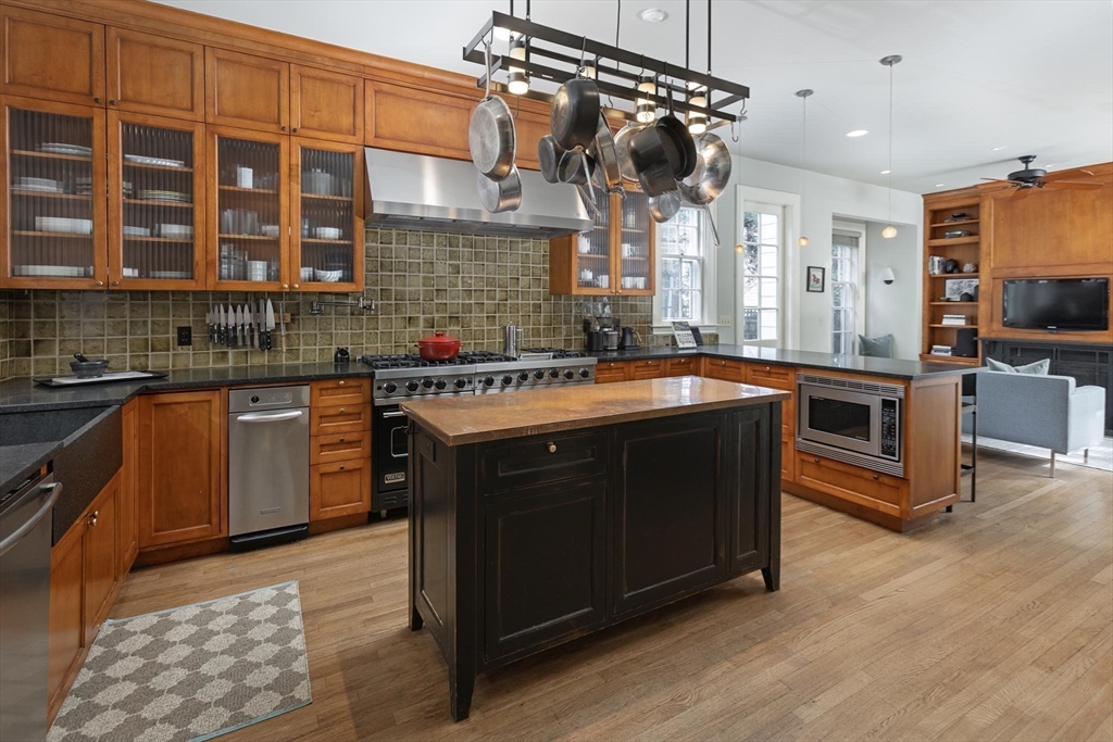 57 Hedge Road Brookline, MA 02445 - Photo 7 of 37 a kitchen with a sink stove and cabinets