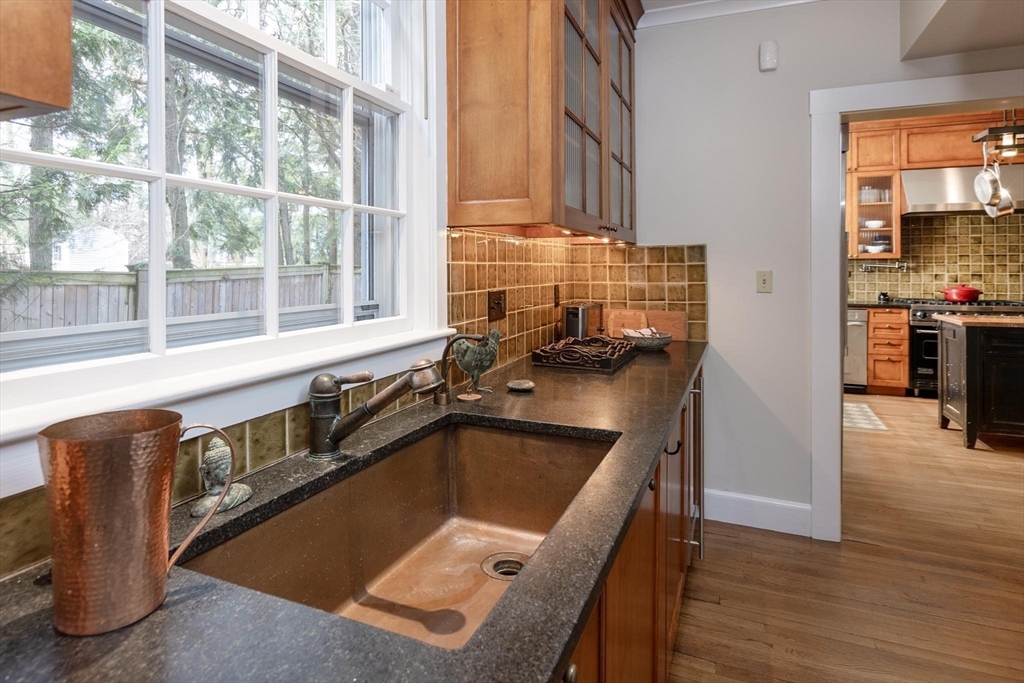 57 Hedge Road Brookline, MA 02445 - Photo 8 of 37 a kitchen with granite countertop a stove a sink and a microwave