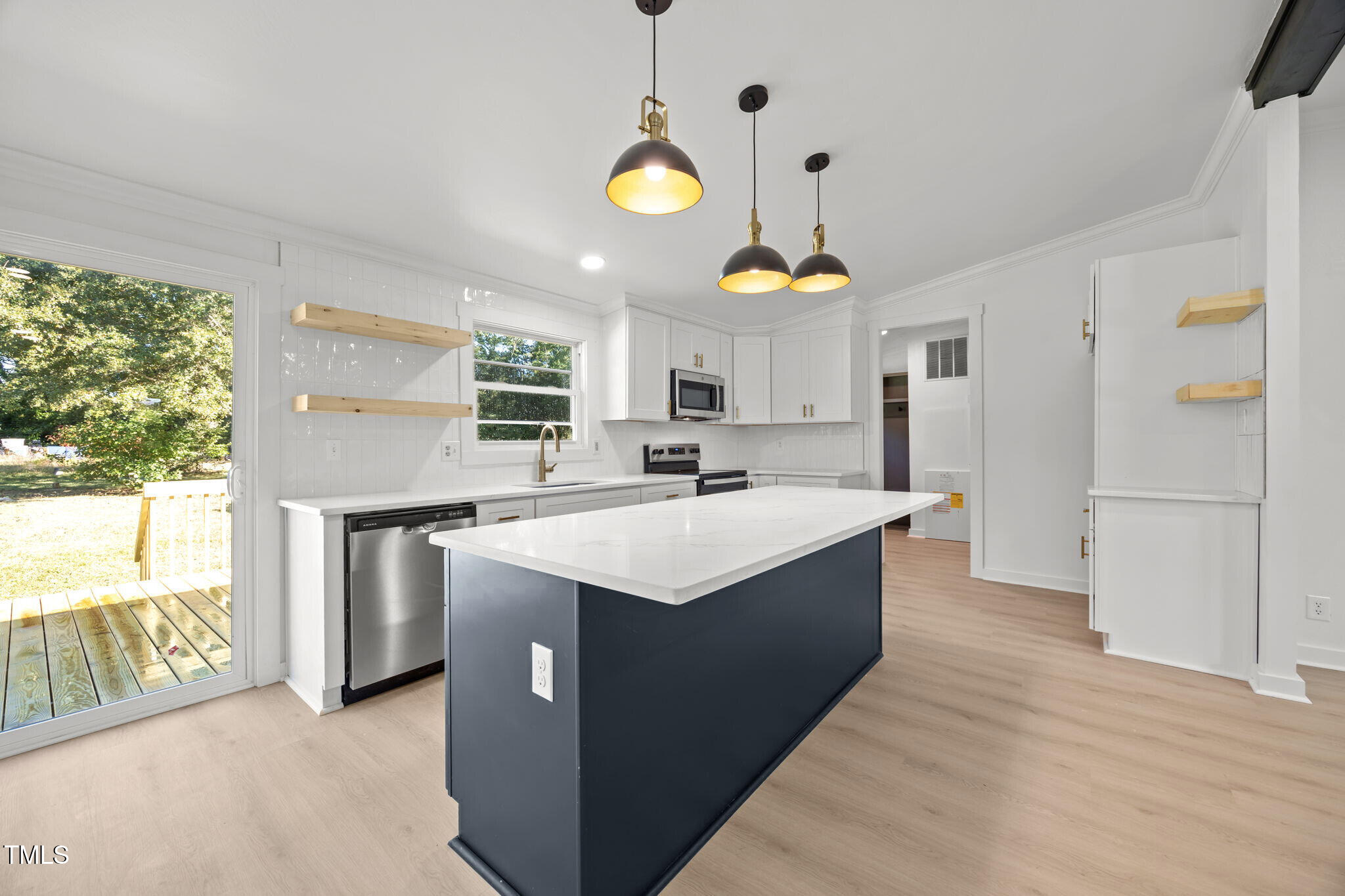 2309 Win Road Garner, NC 27529 - Photo 5 of 35 a kitchen with a sink a counter top space and stainless steel appliances