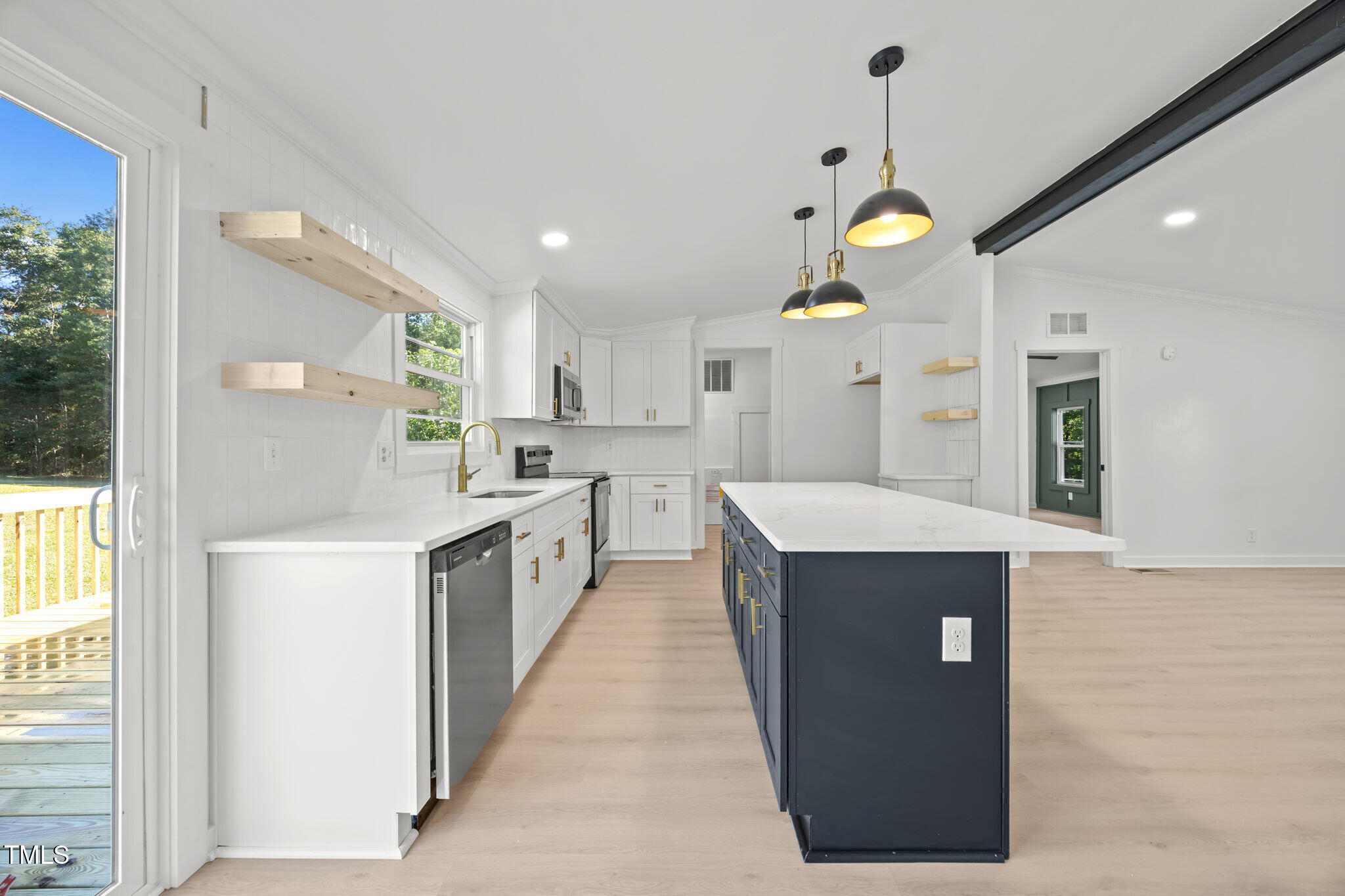 2309 Win Road Garner, NC 27529 - Photo 7 of 35 a large kitchen with granite countertop a large kitchen island in the center and stainless steel appliances