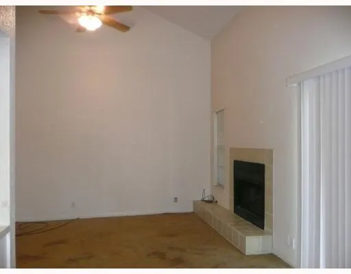 a view of empty room with a fireplace