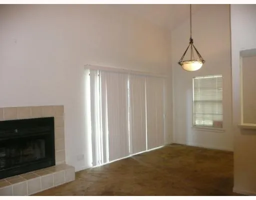 a view of empty room with windows and fireplace