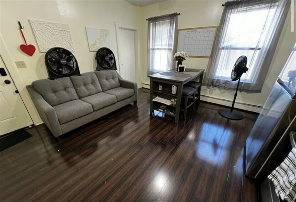 1576 Tremont Street, Unit 2 Boston, MA 02120 - Photo 2 of 13 a living room with furniture and a window