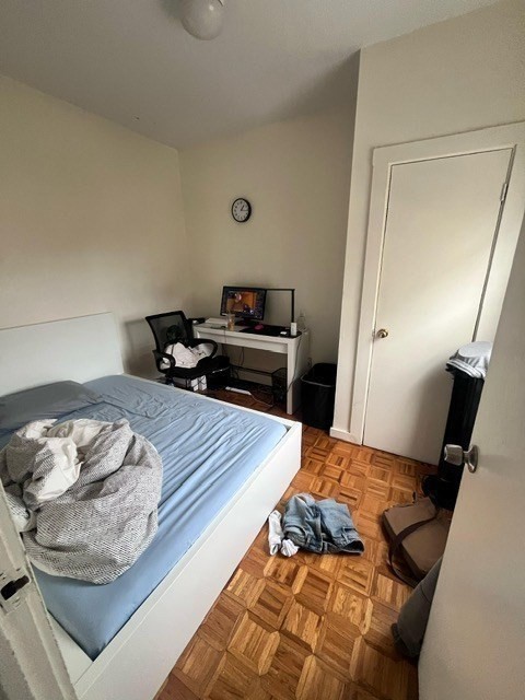 1576 Tremont Street, Unit 2 Boston, MA 02120 - Photo 9 of 13 a bedroom with a bed and a mirror