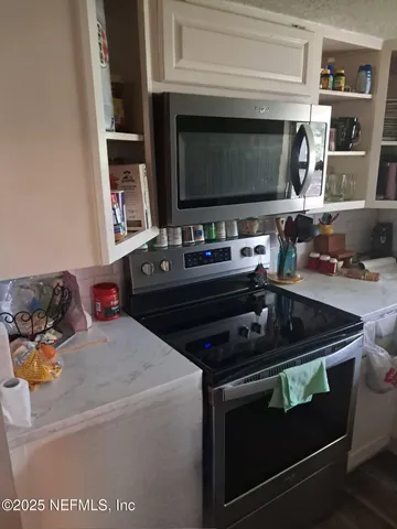 a kitchen with a stove and a microwave