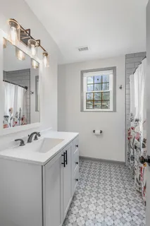 a spacious bathroom with a sink and a mirror