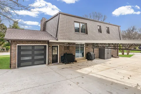 a view of a house with a yard and garage