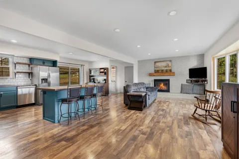 a living room with furniture a dining table and kitchen view