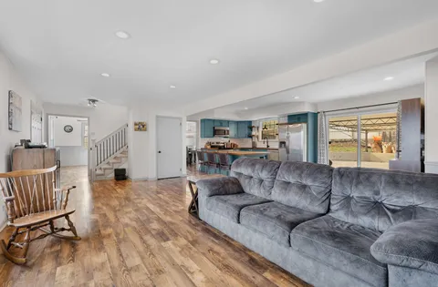 a living room with furniture and a wooden floor
