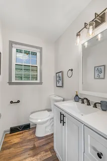 a bathroom with a sink toilet and a mirror