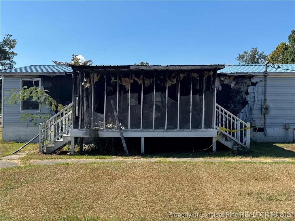 151 Ratley Street Raeford, NC 28376 - Photo 13 of 25 a view of a house with wooden deck and furniture