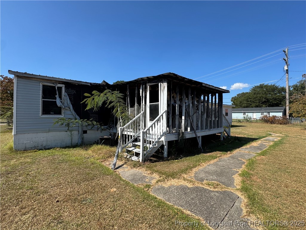 151 Ratley Street Raeford, NC 28376 - Photo 14 of 25 a view of a house with a yard in front of it