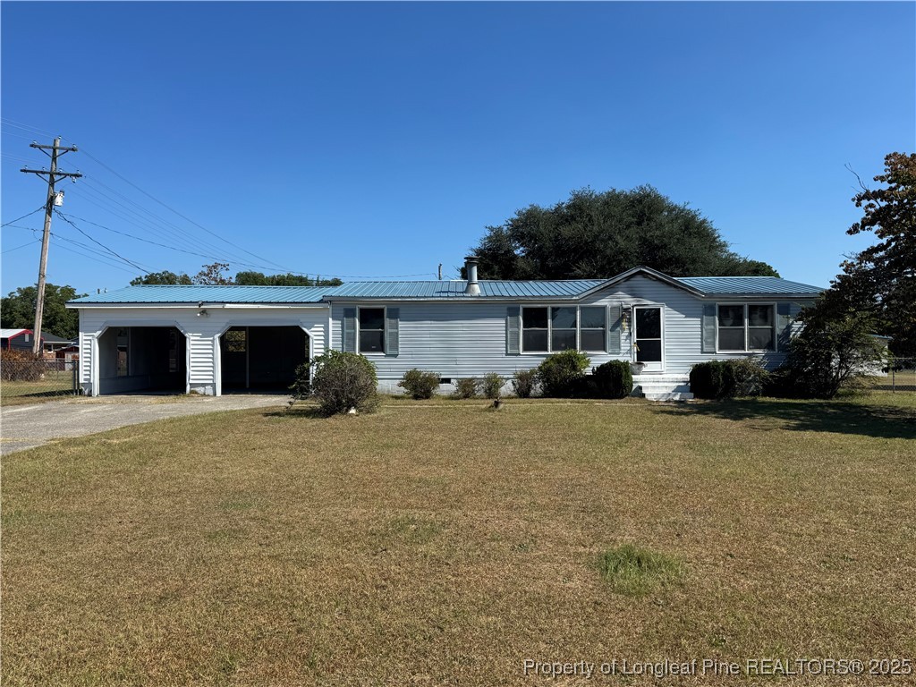 151 Ratley Street Raeford, NC 28376 - Photo 5 of 25 a front view of a house with a garden