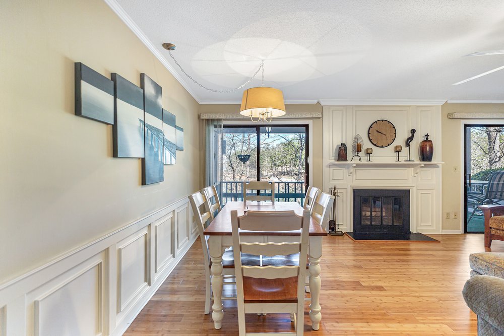 21 Harbor Gate Anderson, SC 29625 - Photo 11 of 44 This inviting dining area features a cozy fireplace and expansive views of the outdoors.