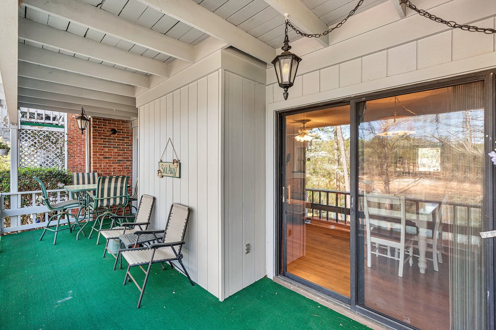 21 Harbor Gate Anderson, SC 29625 - Photo 12 of 44 This inviting porch area offers a delightful space for relaxation and enjoying the outdoor scenery.