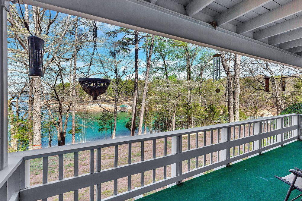 21 Harbor Gate Anderson, SC 29625 - Photo 13 of 44 This inviting porch overlooks a tranquil lake, offering serene views and peaceful relaxation.