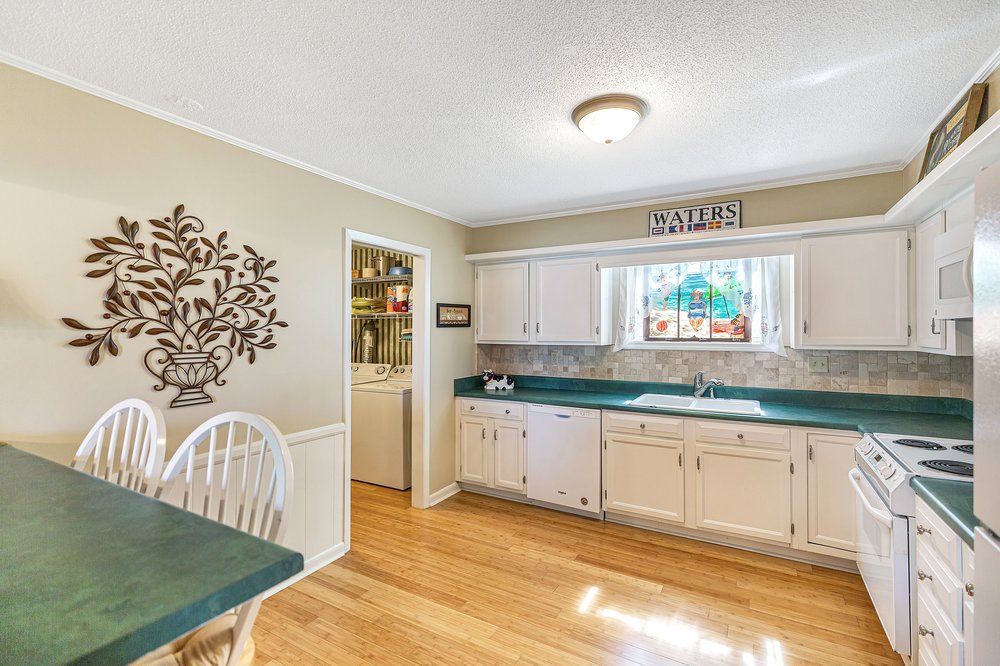 21 Harbor Gate Anderson, SC 29625 - Photo 15 of 44 This bright kitchen with ample storage and counter space seamlessly connects to a convenient laundry area.