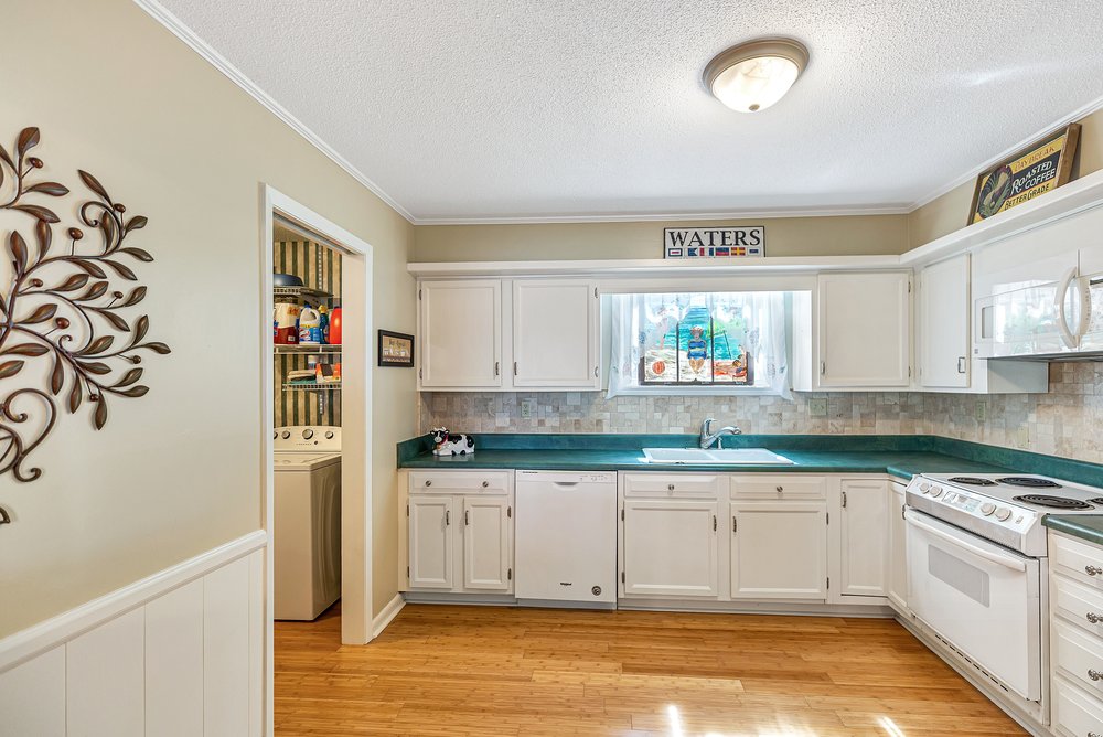 21 Harbor Gate Anderson, SC 29625 - Photo 19 of 44 This bright kitchen features bamboo flooring and a convenient adjoining laundry area, perfect for modern living.