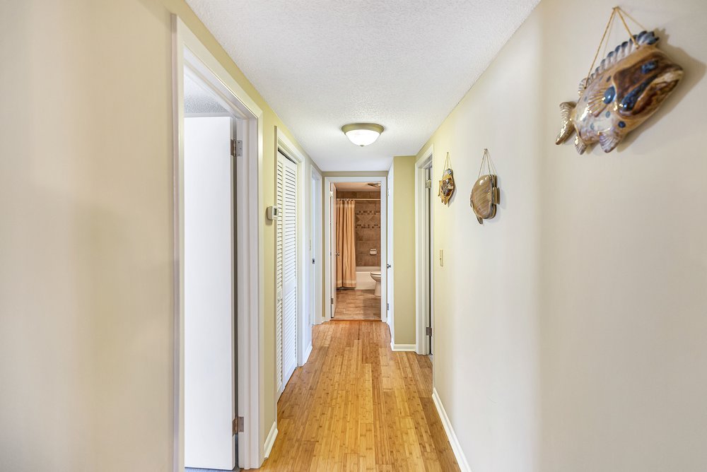 21 Harbor Gate Anderson, SC 29625 - Photo 21 of 44 This interior hallway features beautiful Bamboo flooring, leading to a well-appointed bathroom.