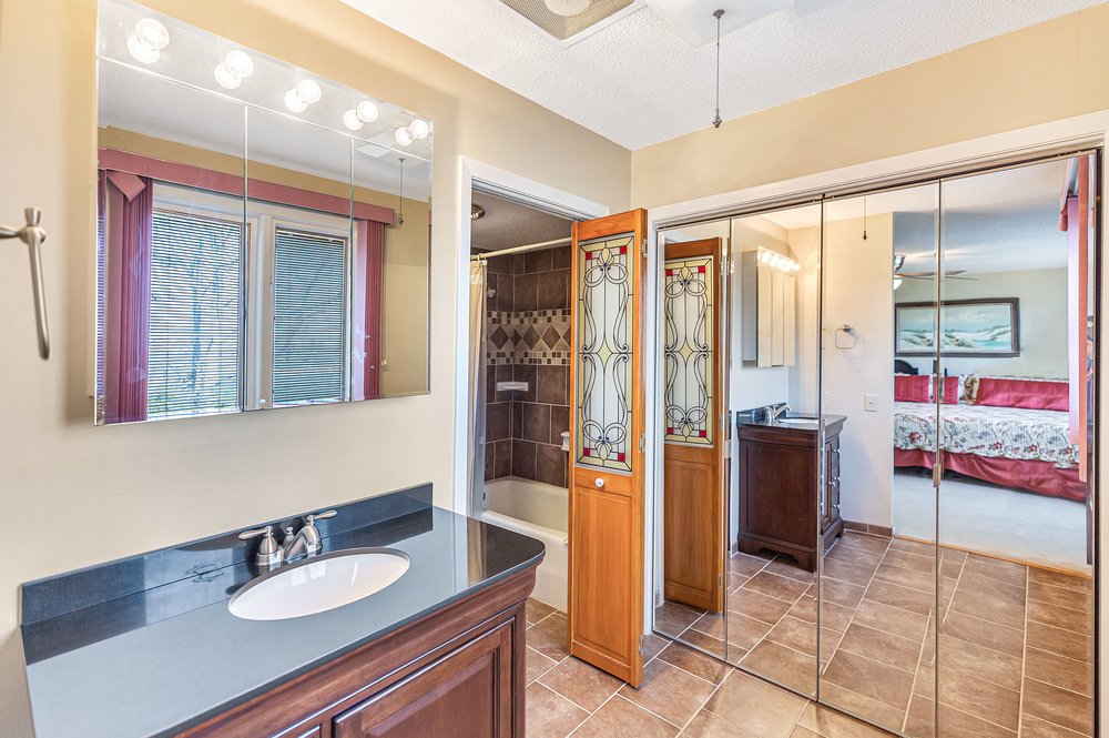 21 Harbor Gate Anderson, SC 29625 - Photo 27 of 44 This bathroom features elegant tile flooring, a spacious vanity with ample storage, and a combined tub and shower.