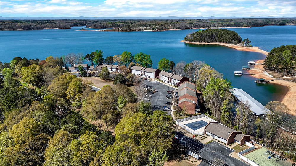 21 Harbor Gate Anderson, SC 29625 - Photo 40 of 44 This aerial view showcases a vibrant community with lakeside living and recreational amenities. The pool will open up soon.