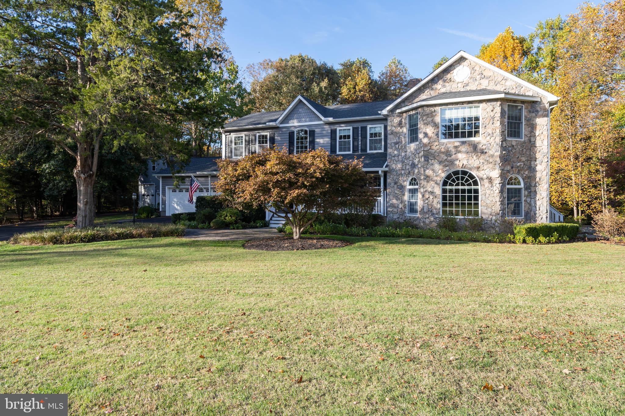 Focus on stone-front addition, outbldg in view.