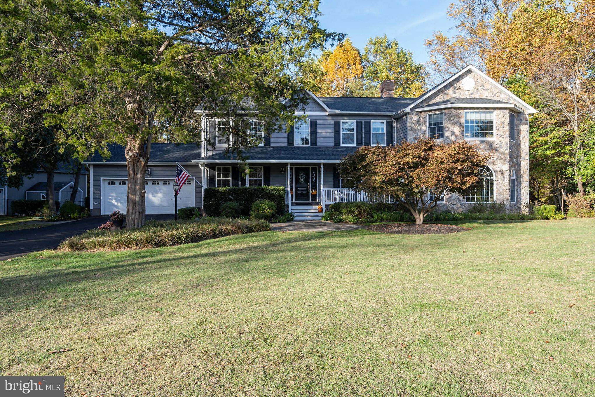 Full front profile with outbldg on left.
