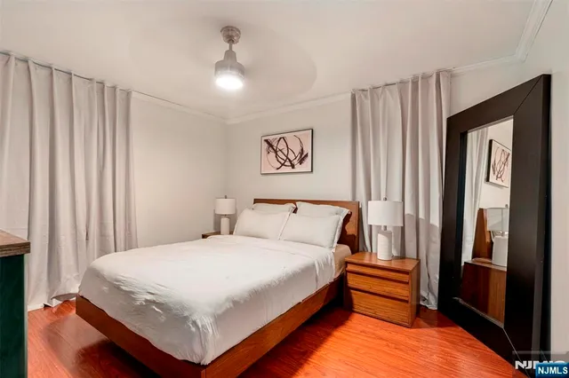 a bedroom with a large bed and a chandelier