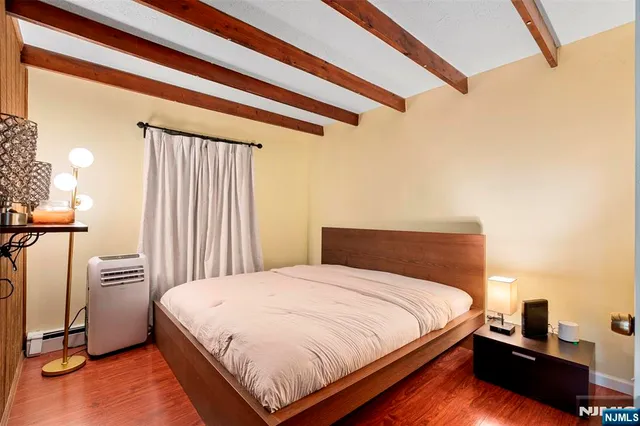 a bedroom with a bed and a night stand