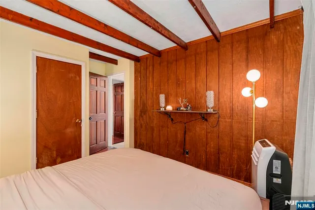 a bedroom with a bed and a shower