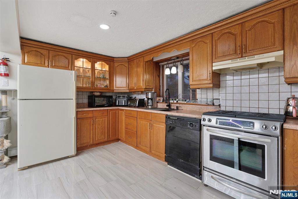 88 Hinchman Avenue Wayne, NJ 07470 - Photo 21 of 37 a kitchen with a stove sink and refrigerator
