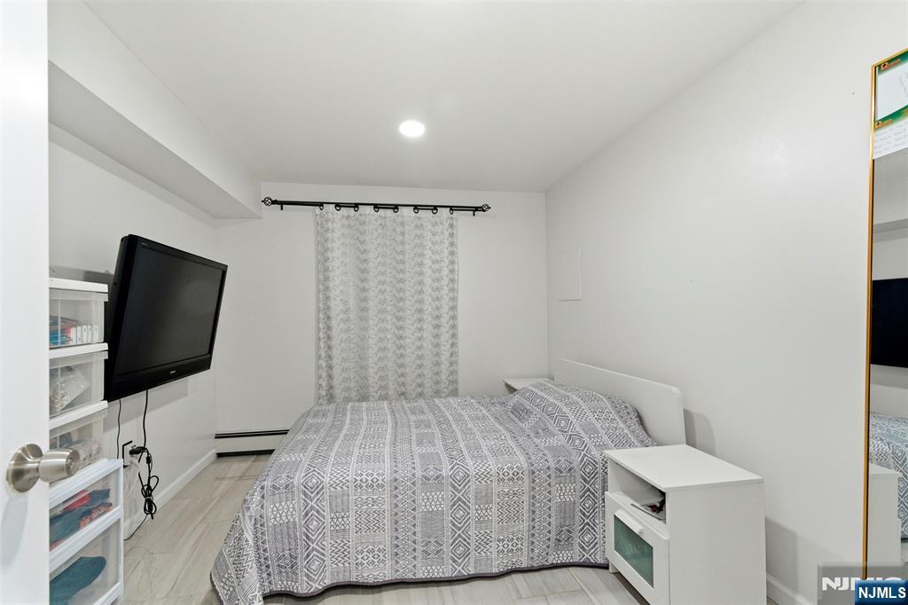 88 Hinchman Avenue Wayne, NJ 07470 - Photo 23 of 37 a bedroom with a bed and a flat screen tv